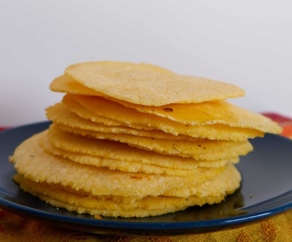 Soft pliable homemade corn tortillas holding steak tacos and corn salsa — corn tortillas without masa harina recipe