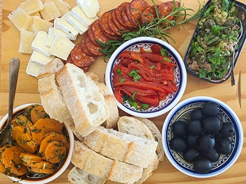 Spanish tapas spread for two with tuna, roasted peppers, olives, and chorizo