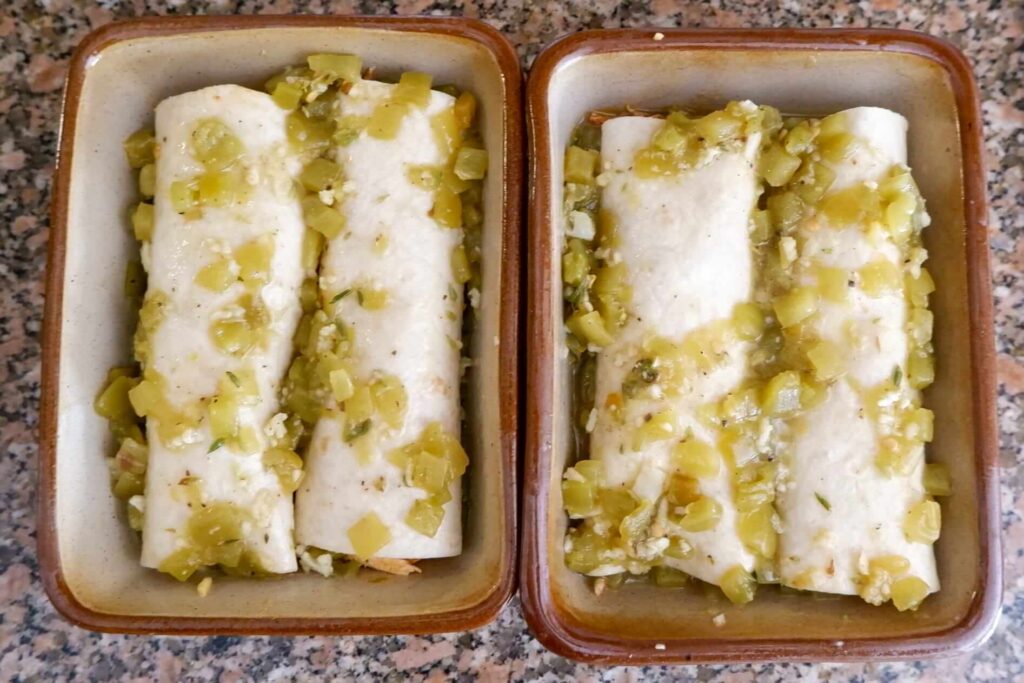 Shredded chicken and cheese rolled into a flour tortilla for green chile chicken enchiladas