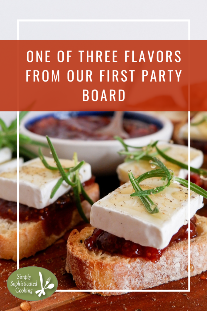 Fig and brie crostini served on party board with a bowl of fig jam for date night